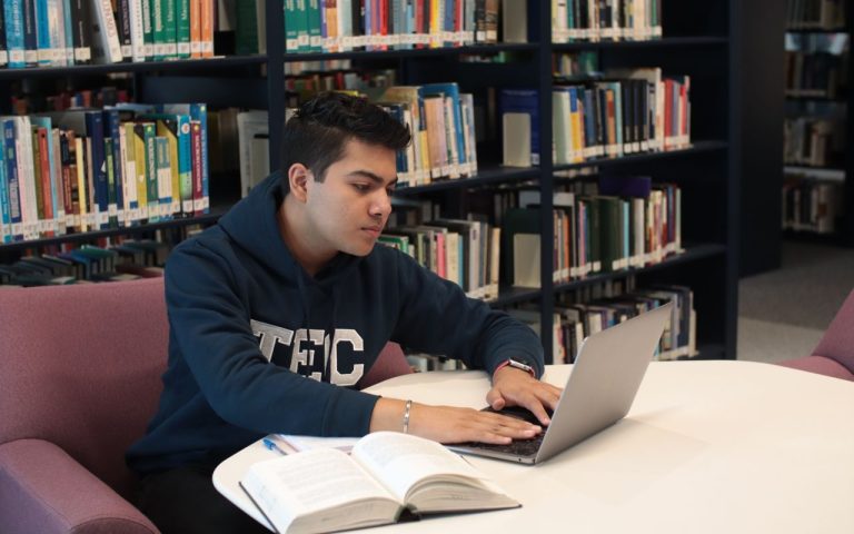 Estudante em uma biblioteca usando computador